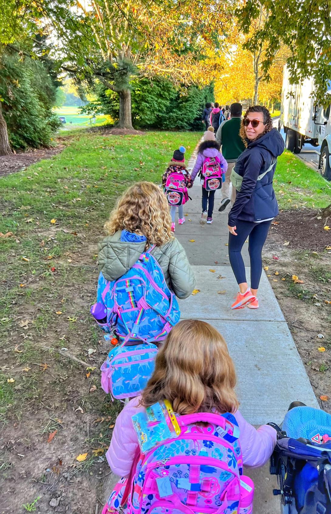 Elementary schoolers walking to Running Brook ES during National Walk or Roll to School Day.