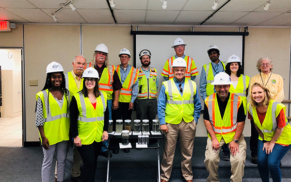 Councilman David Yungmann posing for a group photo in high-visibility construction gear