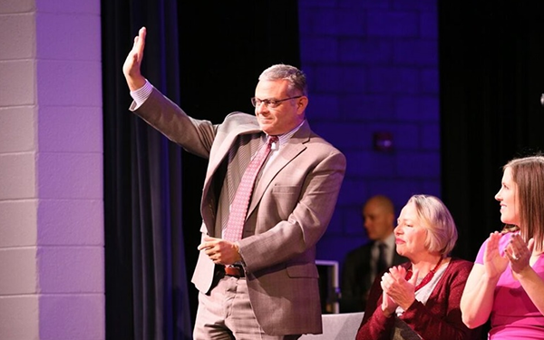 Councilman David Yungmann waving to a crowd at his swearing-in ceremony